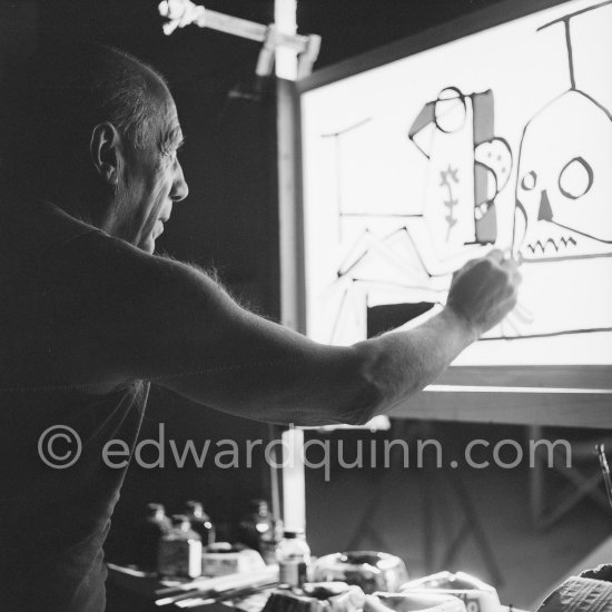 During filming of "Le mystère Picasso". Pablo Picasso working on "Nature morte". Pablo Picasso had a frame constructed on which he could stretch a transluscent piece of paper. He drew on one side, and the camera filmed the drawing being born from the other side. Nice, Studios de la Victorine 1955. - Photo by Edward Quinn