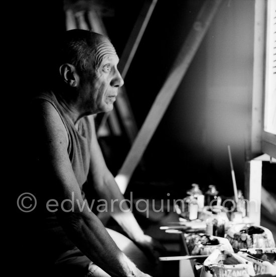During filming of "Le mystère Picasso". Pablo Picasso working on "Nature morte". Pablo Picasso had a frame constructed on which he could stretch a transluscent piece of paper. He drew on one side, and the camera filmed the drawing being born from the other side. Nice, Studios de la Victorine 1955. - Photo by Edward Quinn