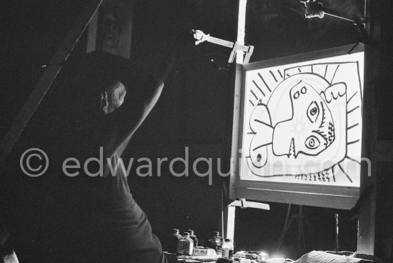 During filming of "Le mystère Picasso". Pablo Picasso working on "Tête de femme" with colored ink. He had a frame constructed on which he could stretch a transluscent piece of paper. He drew on one side, and the camera filmed the drawing being born from the other side. Nice, Studios de la Victorine 1955. - Photo by Edward Quinn