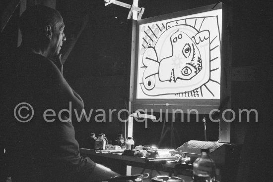 During filming of "Le mystère Picasso". Pablo Picasso working on "Tête de femme" with colored ink. He had a frame constructed on which he could stretch a transluscent piece of paper. He drew on one side, and the camera filmed the drawing being born from the other side. Nice, Studios de la Victorine 1955. - Photo by Edward Quinn