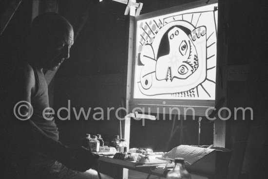 During filming of "Le mystère Picasso". Pablo Picasso working on "Tête de femme" with colored ink. He had a frame constructed on which he could stretch a transluscent piece of paper. He drew on one side, and the camera filmed the drawing being born from the other side. Nice, Studios de la Victorine 1955. - Photo by Edward Quinn