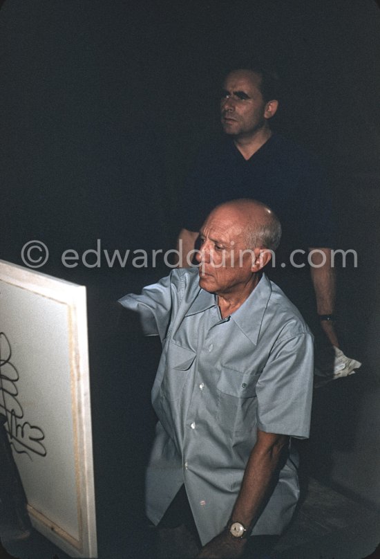 Pablo Picasso at work, Henri-Georges Clouzot in the background. "Le mystère Picasso", Nice, Studios de la Victorine 1955. - Photo by Edward Quinn