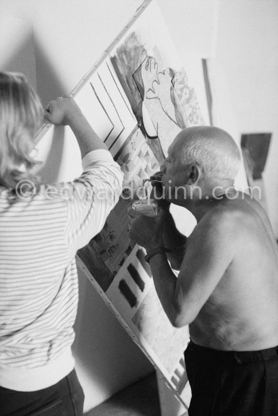 Pablo Picasso with the help of Maya Picasso fixing the charcoal in the painting "Femme nue allongé". Nice, Studios de la Victorine 1955. - Photo by Edward Quinn