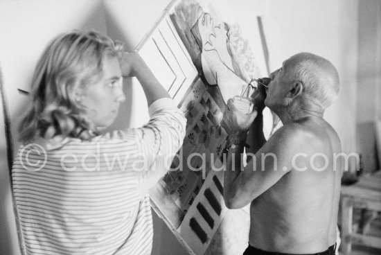 Pablo Picasso with the help of Maya Picasso fixing the charcoal in the painting "Femme nue allongé". Nice, Studios de la Victorine 1955. - Photo by Edward Quinn
