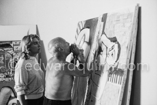 Pablo Picasso with the help of Maya Picasso fixing the charcoal in the painting "Femme nue allongé". Nice, Studios de la Victorine 1955. - Photo by Edward Quinn