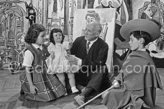 Pablo Picasso with Claude Picasso in "swashbuckler" ("cap et épée") dress. Paloma Picasso with doll. La Californie, Cannes, Christmas 1955. - Photo by Edward Quinn