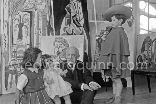 Pablo Picasso with Claude Picasso in "swashbuckler" ("cap et épée") dress. Paloma Picasso with doll. La Californie, Cannes, Christmas 1955. - Photo by Edward Quinn