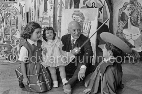 Picasso with Claude in "swashbuckler" (”cap et épée”) dress. Paloma with doll. La Californie, Cannes, Christmas 1955. - Photo by Edward Quinn