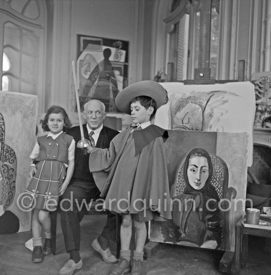 Pablo Picasso with Claude Picasso in "swashbuckler" ("cap et épée") dress. Paloma Picasso with doll. La Californie, Cannes, Christmas 1955. - Photo by Edward Quinn