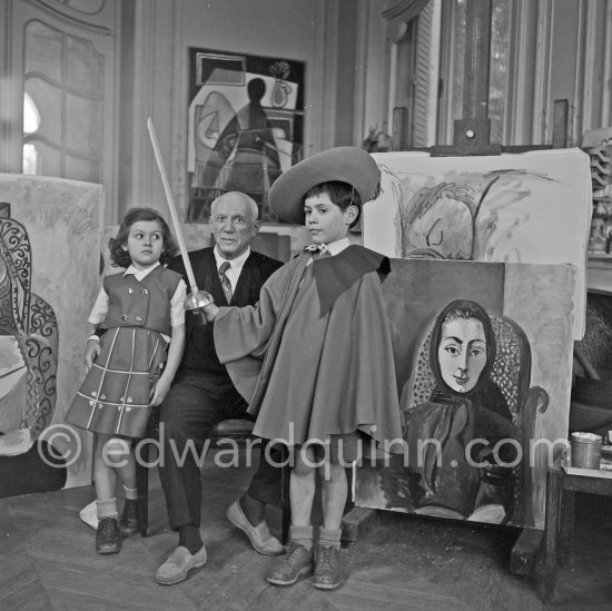 Pablo Picasso with Claude Picasso in "swashbuckler" ("cap et épée") dress. Paloma Picasso with doll. La Californie, Cannes, Christmas 1955. - Photo by Edward Quinn