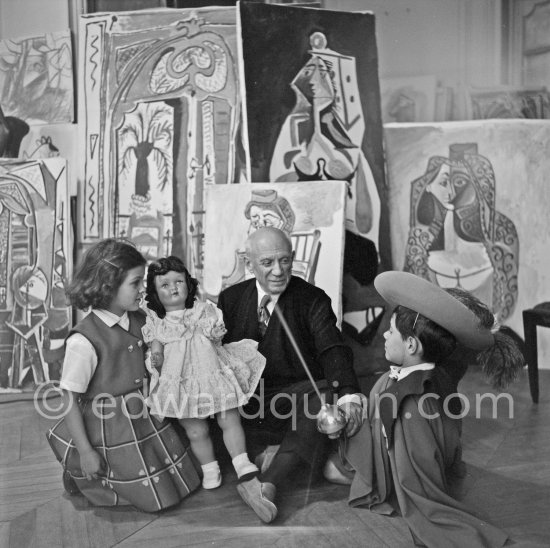 Pablo Picasso with Claude Picasso in "swashbuckler" ("cap et épée") dress. Paloma Picasso with doll. La Californie, Cannes, Christmas 1955. - Photo by Edward Quinn
