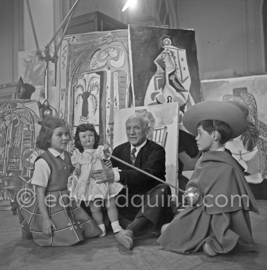 Pablo Picasso with Claude Picasso in "swashbuckler" ("cap et épée") dress. Paloma Picasso with doll. La Californie, Cannes, Christmas 1955. - Photo by Edward Quinn