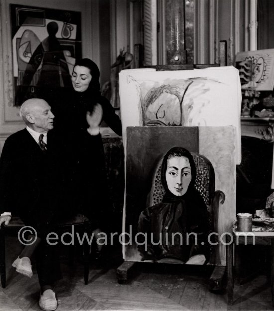 Pablo Picasso and Jacqueline with the painting "Portrait de Jacqueline au rocking-chair et à la mantille noire". La Californie, Cannes 1955. (Digitized from Vintage Print, original negative missing) - Photo by Edward Quinn
