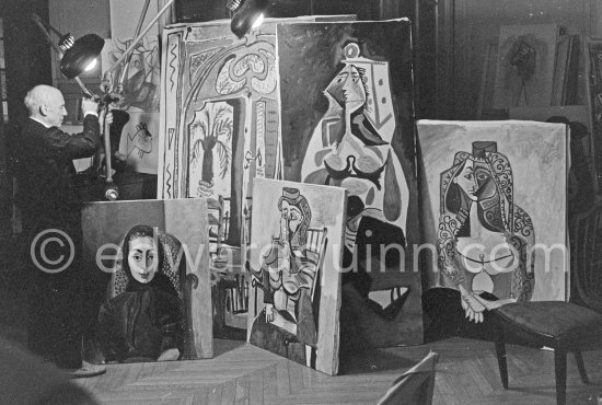 Pablo Picasso illuminating paintings. La Californie, Cannes 1955. - Photo by Edward Quinn