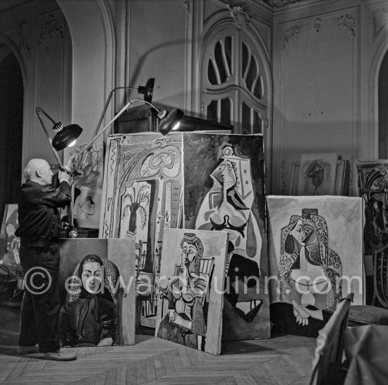 Pablo Picasso illuminating paintings. La Californie, Cannes 1955. - Photo by Edward Quinn