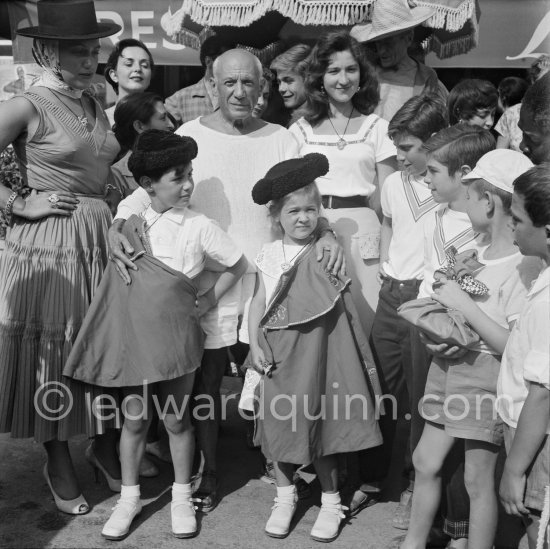 Pablo Picasso proudly poses with daughter Maya Picasso (left), son Claude Picasso and Paloma Picasso in miniature toreador costumes. In front of restaurant Le Vallauris. Vallauris 1955. - Photo by Edward Quinn