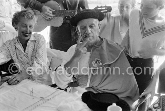 Local Corrida. Pablo Picasso as bullfighter. Restaurant Le Vallauris. On the left Francine Weisweiller. Vallauris 1955. - Photo by Edward Quinn