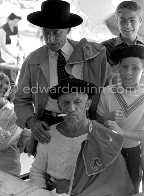 At the lunch given for his friends by Pablo Picasso at restaurant Le Vallauris before the bullfight, Pablo Picasso and Cocteau dress up as toreadors for their friends. Behind them the sons of the writer José Herrera-Petere. Vallauris 1955. - Photo by Edward Quinn