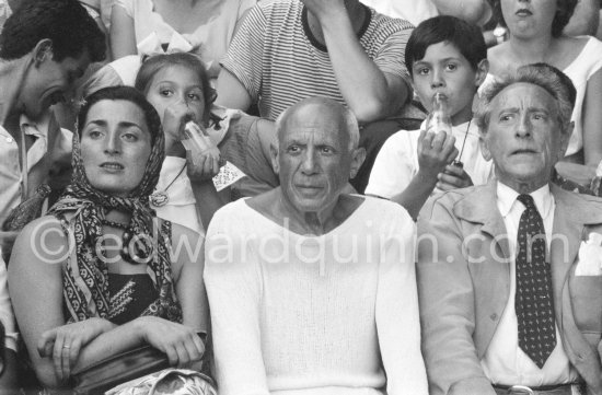 On the grandstand of a bullfight put on in Pablo Picasso's honor. From left: Jacqueline, Pablo Picasso, Jean Cocteau. Behind them Paloma Picasso and Claude Picasso. Vallauris 1955. - Photo by Edward Quinn