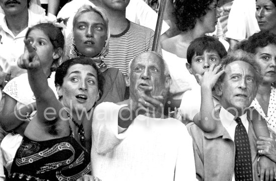 On the grandstand of a bullfight put on in Pablo Picasso\'s honor. From left: Jacqueline, Pablo Picasso, Jean Cocteau. Behind them Paloma Picasso, Maya Picasso and Claude Picasso. Vallauris 1955. - Photo by Edward Quinn