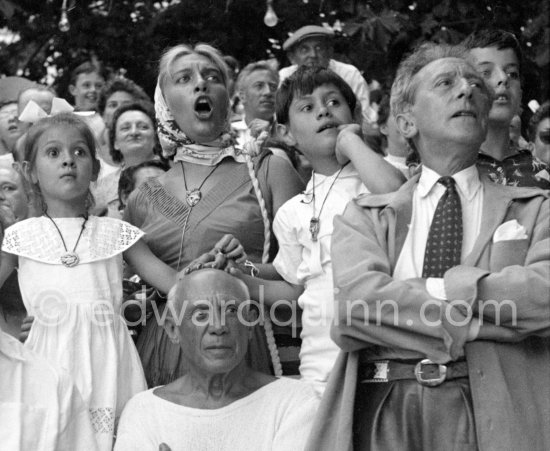 At one moment during the corrida Pablo Picasso’s three children all put their hands on their father’s head. On the right is Jean Cocteau. Vallauris 1955. - Photo by Edward Quinn