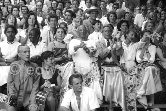 Local Corrida. Jacqueline, Maya Picasso, Pablo Picasso, Claude Picasso, Paloma Picasso, Jean Cocteau, Francine Weisweiller and daughter, Jacques-Henri Lartigue, photographer (with his Rolleiflex), Weisweiller, Francine. Vallauris 1955. - Photo by Edward Quinn