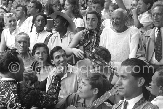 On the grandstand of a bullfight put on in Pablo Picasso\'s honor. From left: Jacques-Henri Lartigue, photographer, his wife Florette, Javier Vilató and wife Germaine Lascaux, Jacqueline, Pablo Picasso, Jean Cocteau. Behind them Maya Picasso and Claude Picasso. Interview RTF: http://www.ina.fr/audio/P13108794/corrida-a-Vallauris-ete-1955.-audio.html - Photo by Edward Quinn