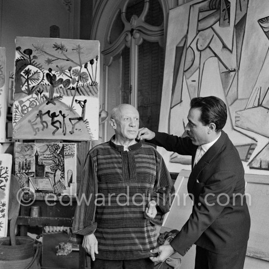 Michele Sapone, Italian tailor, fits a new garment he has made as a birthday present for Pablo Picasso. In return Pablo Picasso gave him drawings. La Californie, Cannes 1956. - Photo by Edward Quinn