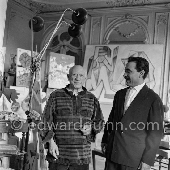 Michele Sapone, Italian tailor, fits a new garment he has made for Pablo Picasso. In return Pablo Picasso gives him drawings. La Californie, Cannes 1956. - Photo by Edward Quinn