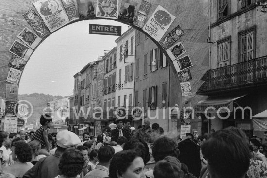 Pablo Picasso at the traditional parade after a local corrida in a Renault 1925 with bull\'s horns. On the left Claude Picasso. Vallauris 1956. Avenue Georges Clément 14, on the right entrance to Nérolium. Vallauris 1956. Same situation of today see Pic560419 - Photo by Edward Quinn