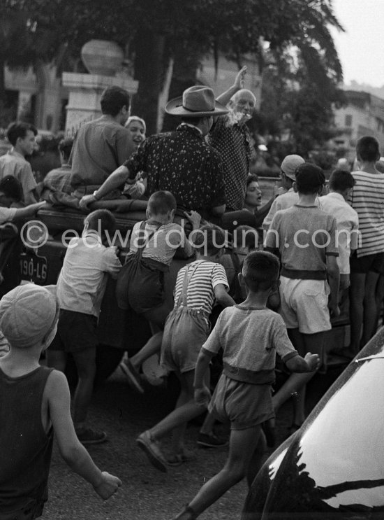 Pablo Picasso and Maya Picasso at the traditional parade after a local corrida in the Renault 1925 with bull's horns. Vallauris 1956 - Photo by Edward Quinn