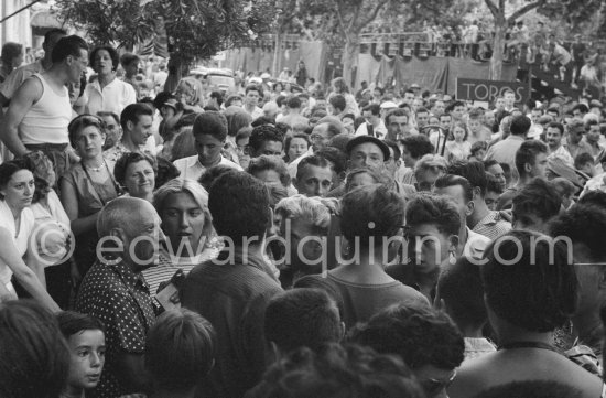 Pablo Picasso and Maya Picasso in the crowd. Before the local Corrida, Vallauris 1956. - Photo by Edward Quinn