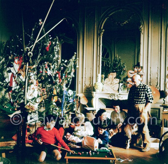 At Christmas with Esmeralda, the goat Pablo Picasso received from Jacqueline. Pablo Picasso, Inès Sassier, Pablo Picasso's housekeeper, Jacqueline, Claude Picasso, Paloma Picasso, Catherine Hutin, Gérard Sassier. La Californie, Cannes 1956. - Photo by Edward Quinn