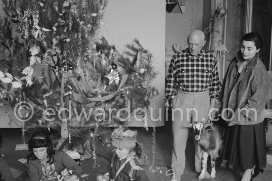 Piccaso at Christmas with Esmeralda, the goat he received from Jacqueline. Jacqueline, Paloma Picasso, Catherine Hutin. La Californie, Cannes 1956. - Photo by Edward Quinn