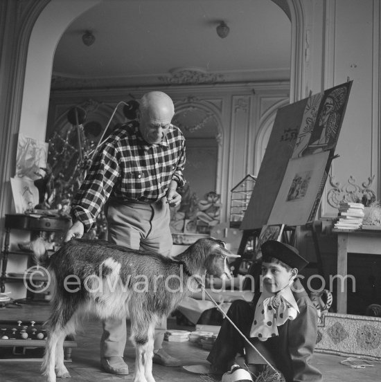 Pablo Picasso with Claude Picasso dressed up as a clown. With goat Esmeralda. La Californie, Cannes 1956. - Photo by Edward Quinn