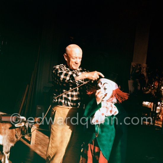 Pablo Picasso with Claude Picasso dressed up as a clown. With goat Esmeralda. La Californie, Cannes 1956. - Photo by Edward Quinn