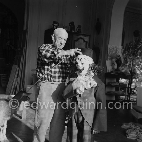 Pablo Picasso with Claude Picasso dressed up as a clown. With goat Esmeralda. La Californie, Cannes 1956. - Photo by Edward Quinn