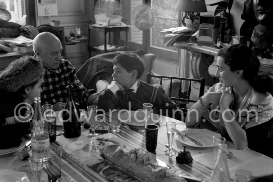 Pablo Picasso, Jacqueline, Paloma Picasso and Claude Picasso at Christmas. Paloma Picasso is wearing the Davy Crockett outfit she received as a Christmas present. La Californie, Cannes 1956. - Photo by Edward Quinn