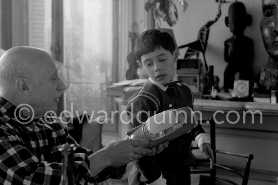 Pablo Picasso and Claude Picasso at Christmas with Claude Picasso\'s Christmas present, a toy Citroën DS. La Californie, Cannes 1956. - Photo by Edward Quinn