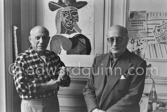 Pablo Picasso and his friend and secretary Jaime Sabartés with the book Pablo Picasso: documents iconographiques. La Californie, Cannes 1956. - Photo by Edward Quinn