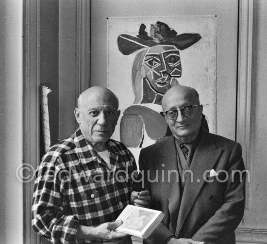 Pablo Picasso and his friend and secretary Jaime Sabartés with the book Pablo Picasso: documents iconographiques. La Californie, Cannes 1956. - Photo by Edward Quinn