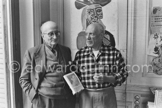 Pablo Picasso and his friend and secretary Jaime Sabartés with the book Pablo Picasso: documents iconographiques. La Californie, Cannes 1956. - Photo by Edward Quinn