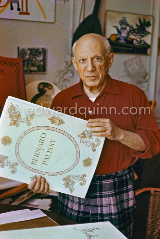 Pablo Picasso with with a book about Bernard Palissy, French potter of the 16th century. La Californie, Cannes 1957. - Photo by Edward Quinn