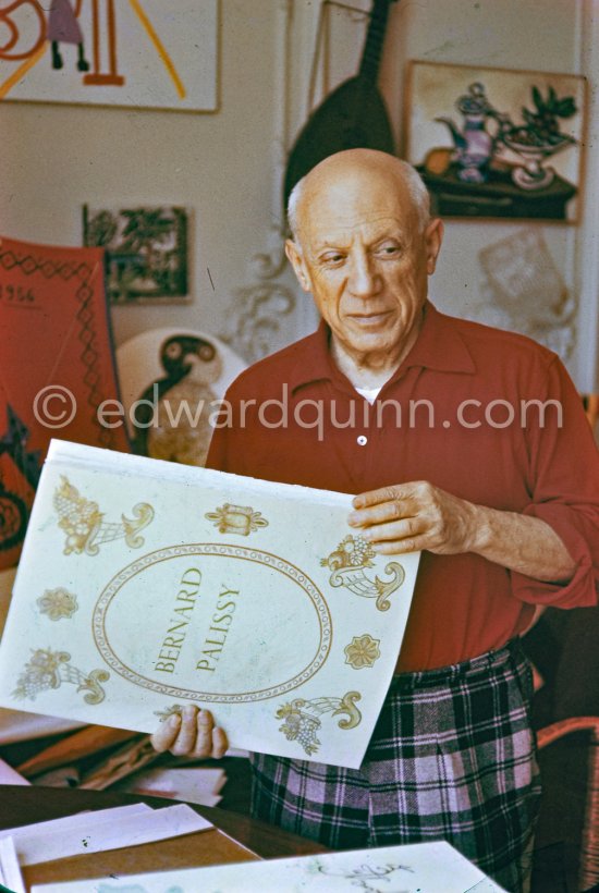 Pablo Picasso with with a book about Bernard Palissy, French potter of the 16th century. La Californie, Cannes 1957. - Photo by Edward Quinn