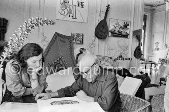 Picasso and Jacqueline viewing a book about Bernard Palissy, French potter of the 16th century. La Californie, Cannes 1957. - Photo by Edward Quinn