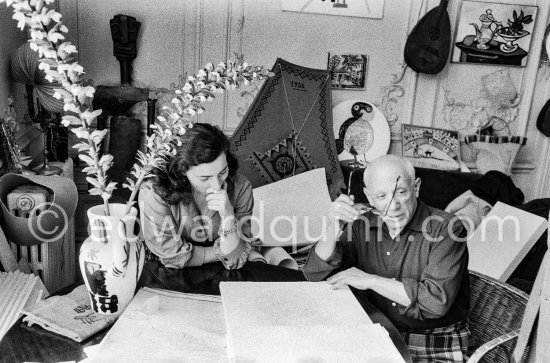 Picasso and Jacqueline viewing a book about Bernard Palissy, French potter of the 16th century. La Californie, Cannes 1957. - Photo by Edward Quinn