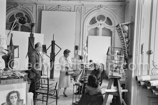 Pablo Picasso showing Suzanne and George Ramié wood sculptures "The Bathers (Les Baigneuses)". On the right Jacqueline. La Californie, Cannes 1957. - Photo by Edward Quinn