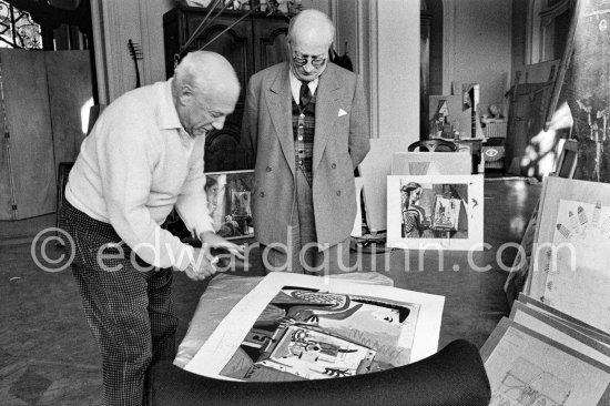 Pablo Picasso dedicates "Femme dans l'atelier" to Edward Quinn. With Jaime Sabartés. La Californie, Cannes 21.11.1957. - Photo by Edward Quinn