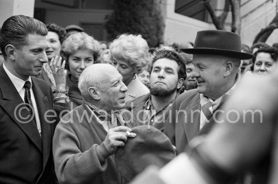 Pablo Picasso, Paulo Picasso, Maurice Thorez. Unveiling of mural "The Fall of Icarus" ("La chute d\'Icare") for the conference hall of UNESCO building in Paris. The mural is made up of forty wooden panels. Initially titled "The Forces of Life and the Spirit Triumphing over Evil", the composition was renamed in 1958 by George Salles, who preferred the current title, "The Fall of Icarus" ("La chute d\'Icare"). Vallauris, 29 March 1958. - Photo by Edward Quinn