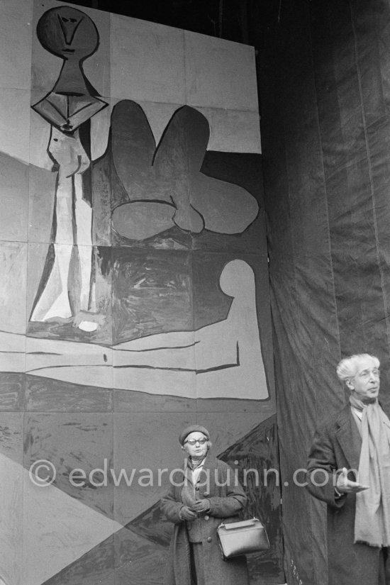 Georges Salles, President of the ICOM and Marie Cuttoli, close friend and collector of Pablo Picasso\'s works. Unveiling of mural "The Fall of Icarus" ("La chute d\'Icare") for the conference hall of UNESCO building in Paris. The mural is made up of forty wooden panels. Initially titled "The Forces of Life and the Spirit Triumphing over Evil", the composition was renamed in 1958 by George Salles, who preferred the current title, "The Fall of Icarus" ("La chute d\'Icare"). Vallauris, 29 March 1958. - Photo by Edward Quinn